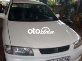 Mazda 323 2000 - Cần bán xe Mazda 323 đời 2000, màu trắng giá 68 triệu tại Đồng Nai